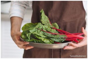 Chef-prepares-beet-leafy-greens-for-meal